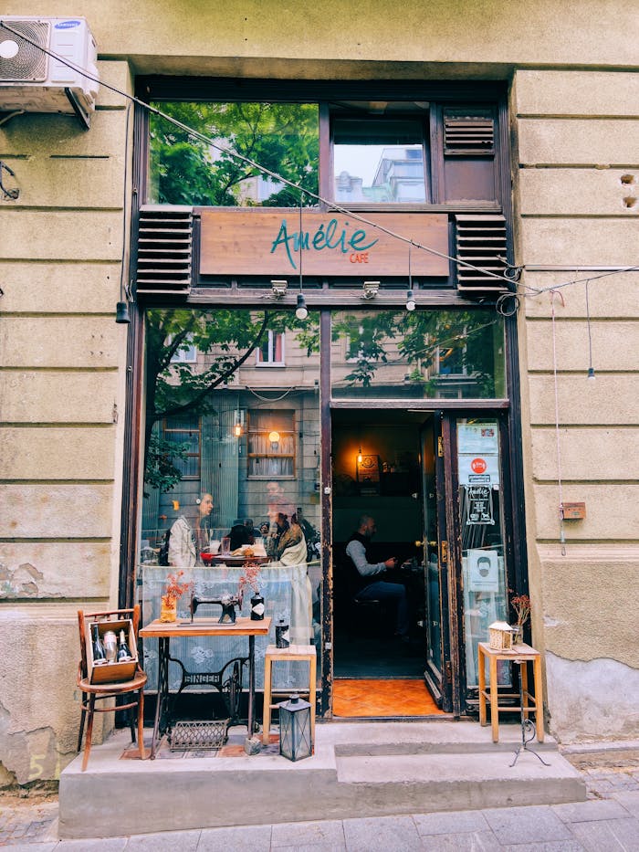 Exterior view of a charming cafe in Belgrade with people enjoying a relaxed atmosphere.